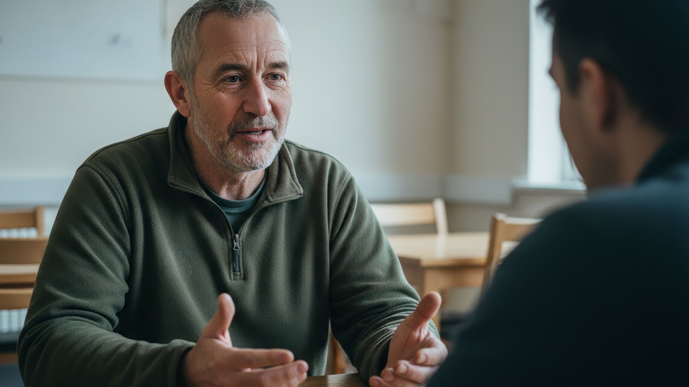Person creating art at a table with painting supplies